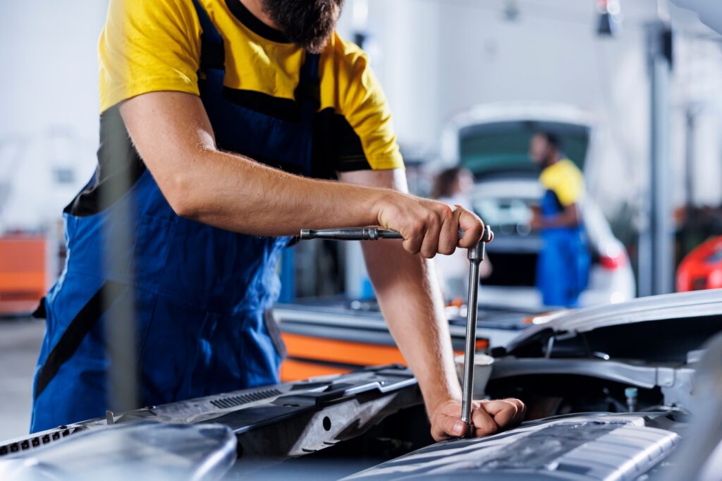 Car service expert examines engine